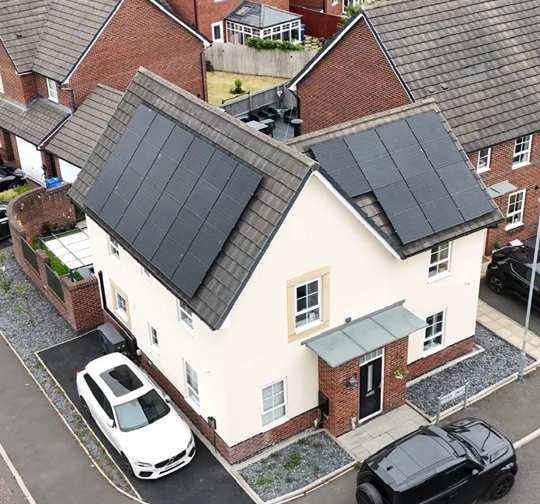 Arial shot of solar panels on a roof.